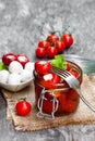 Marinated cherry tomatoes stuffed with mozzarella and spices on