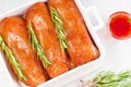 Raw meat in the marinade. Marinated Chicken Breast with spices and rosemary. Sottilissime raw fillet with spices and Royalty Free Stock Photo