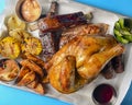 Marinated chicken with seasonings, BBQ ribs, grilled corn served with fresh vegetables and sauce Royalty Free Stock Photo