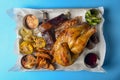 Marinated chicken with seasonings, BBQ ribs, grilled corn served with fresh vegetables and sauce Royalty Free Stock Photo