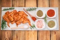 Marinated chicken wings raw.Chicken wings marinated in red sauce on a plate on a wooden background with different spices. Raw Royalty Free Stock Photo