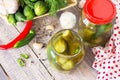 Marinated cucumbers gherkins. Pickles with Chili pepper on the kitchen wooden table