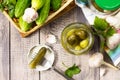 Marinated cucumbers gherkins. Pickles gherkins with garlic wooden table.