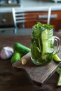 Marinated cucumbers gherkins. Pickles with mustard and garlic. Glass jar with fermented cucumbers on grey table. Pickled cucumbers Royalty Free Stock Photo