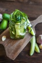 Marinated cucumbers gherkins. Pickles with mustard and garlic. Glass jar with fermented cucumbers on grey table. Pickled cucumbers Royalty Free Stock Photo