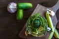 Marinated cucumbers gherkins. Pickles with mustard and garlic. Glass jar with fermented cucumbers on grey table. Pickled cucumbers Royalty Free Stock Photo