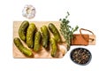 Marinated cucumbers gherkins on wooden cutting board. Pickles with mustard and garlic. Isolated on white background. Top Royalty Free Stock Photo