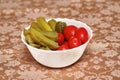 Marinated cucumbers and red tomatoes in a white plate, close-up Royalty Free Stock Photo