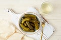 Marinated gherkins in a bowl and pickled juice or cucumber pickle Royalty Free Stock Photo
