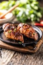 Marinated grilled chicken breast in BBQ sauce and served on a cast iron pan - Close up Royalty Free Stock Photo