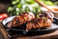 Marinated grilled chicken breast in BBQ sauce and served on a cast iron pan - Close up Royalty Free Stock Photo