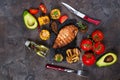 Marinated grilled healthy chicken breasts cooked on BBQ and served with fresh tomato, avocado, potatoes and corn Royalty Free Stock Photo