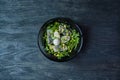 Marinated herring with arugula, onions, boiled quail eggs and lemon juice and olive oil. Delicious salad. Proper nutrition. Dark Royalty Free Stock Photo