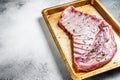 Marinated lamb mutton ribs with herbs and thyme in baking dish. White background. Top view. Copy space Royalty Free Stock Photo