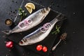 Marinated mackerel or herring fish with spices, greens and onion on slate stone background. Mediterranean food, appetizer, seafood