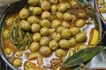 Marinated olives with herbs in a market.