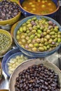 Marinated olives with herbs in a market.