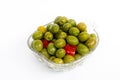 Marinated olives in small transparent bowl. On white background Royalty Free Stock Photo