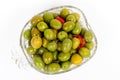 Marinated olives in small transparent bowl. On white background. Pickled green olives Royalty Free Stock Photo