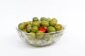 Marinated olives in small transparent bowl. On white background. Pickled green olives Royalty Free Stock Photo