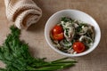 Marinated oyster mushrooms, garnished with cherry tomatoes and green dill. A dish with onions and butter in a white plate with a b