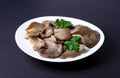 Marinated Oyster Mushrooms with parsley leaf on a plate isolated