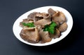 Marinated oyster mushrooms with parsley leaf on a white plate