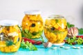 Marinated preserving jars. Homemade orange cut pumpkin pickles with red hot chili peppers, fresh parsley, spices on light Royalty Free Stock Photo