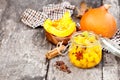 Marinated pumpkin dices in a glass container on a wooden table. Royalty Free Stock Photo