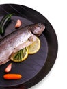 Marinated rainbow trout with lemon, garlic on frying pan