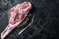 Marinated raw lamb mutton Leg Thigh with thyme and spices. Black background. Top view. Copy space Royalty Free Stock Photo