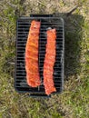 Marinated ribs are grilled outdoors