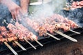 Marinated shashlik preparing on a barbecue grill over charcoal. Roasted stacked meat Shish kebab popular Eastern Europe. Shashlyk