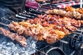 Marinated shashlik preparing on a barbecue grill over charcoal. Shashlik or Shish kebab popular in Eastern Europe. Royalty Free Stock Photo