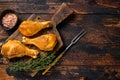 Marinated and Smoked chicken legs drumsticks on a wooden cutting board. Dark wooden background. Top view. Copy space Royalty Free Stock Photo