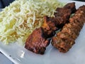 Marinated spice grilled beef and chicken kebab skewers Persian style with saffon rice on white plate Royalty Free Stock Photo