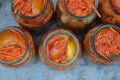 Marinated tomatoes. Grated carrot, Red and yellow tomatoes in jars