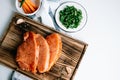 Marinated turkey steak with spices on a wooden board with carrot sticks and herbs on the table Royalty Free Stock Photo