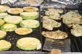 Marinated turkey steaks and zucchini medallions cooking on grill Royalty Free Stock Photo