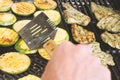 Marinated turkey steaks and zucchini medallions cooking on grill