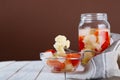 Marinated various vegetables in a glass jar on white wooden background Royalty Free Stock Photo