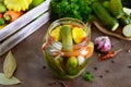 Marinated vegetables in a glass jar. Assorted cucumbers, peppers, carrots, patissons, zucchini.