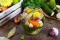 Marinated vegetables in a glass jar. Assorted cucumbers, peppers, carrots, patissons, zucchini. Royalty Free Stock Photo