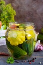 Marinated vegetables in a glass jar. Assorted cucumbers, peppers, carrots, patissons, zucchini.