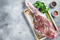 Marinated whole mutton leg, raw lamb meat with thyme, spices and olive oil. Gray background. Top view. Copy space Royalty Free Stock Photo