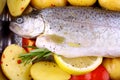 Marinated whole trout with red pepper, potato and lemon
