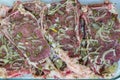 Marinating meat with spices, close up. Fresh-marinated raw steak with herbs and spices. Royalty Free Stock Photo