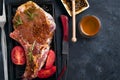 Marinating raw lamb chops with spices, honey and tomato on grill pan, close up Royalty Free Stock Photo