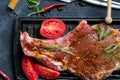 Marinating raw lamb chops with spices, honey and tomato on grill pan, close up Royalty Free Stock Photo