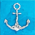 Marine anchor made of seashells on the blue background